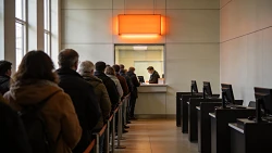 A long queue waiting at a single service counter while the others sit empty